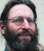 Headshot of environment expert with full brown beard and glasses